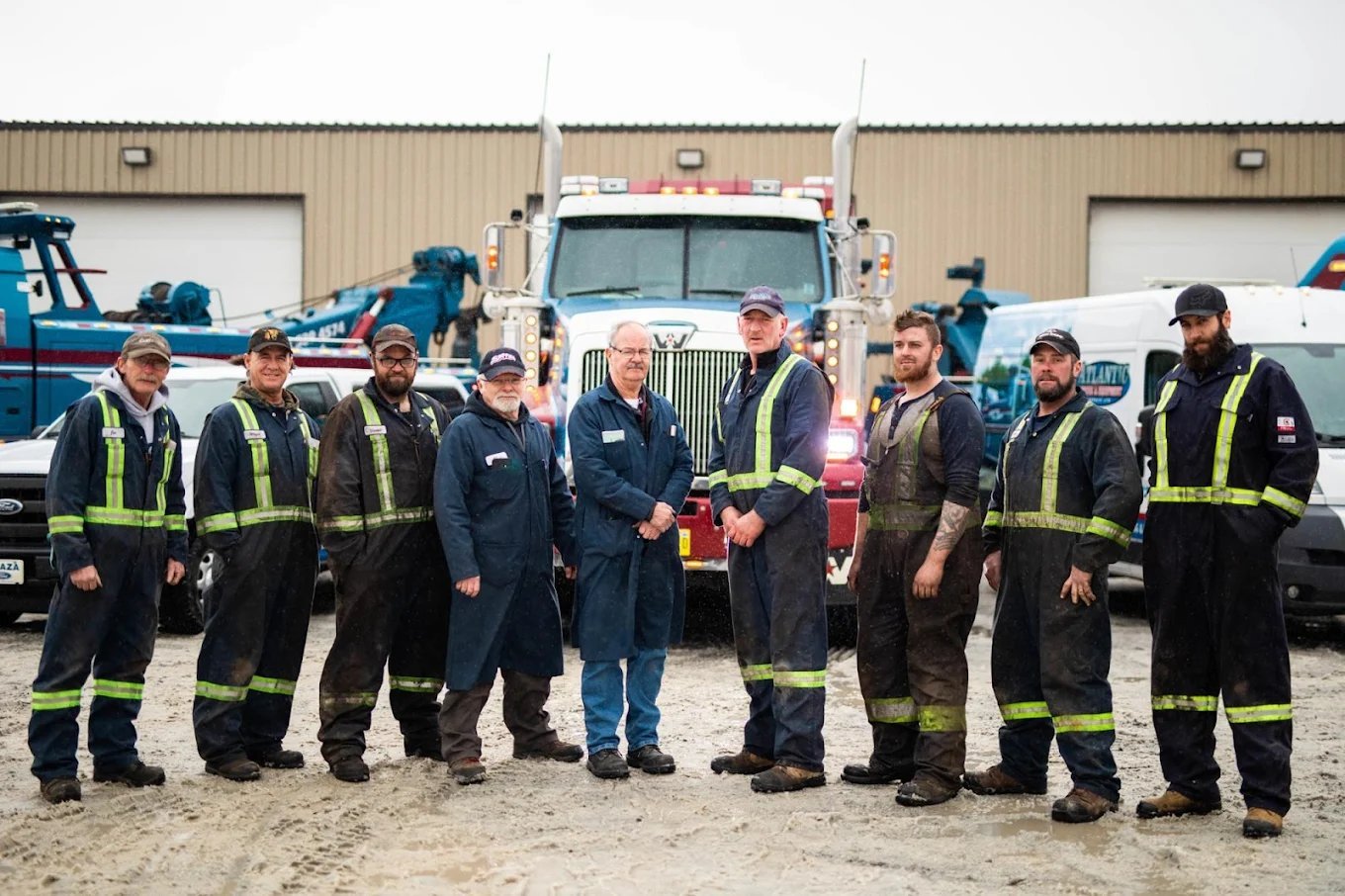 The Atlantic Truck & Equipment Repair team — 9 certified mechanics and technicians in front of the fleet